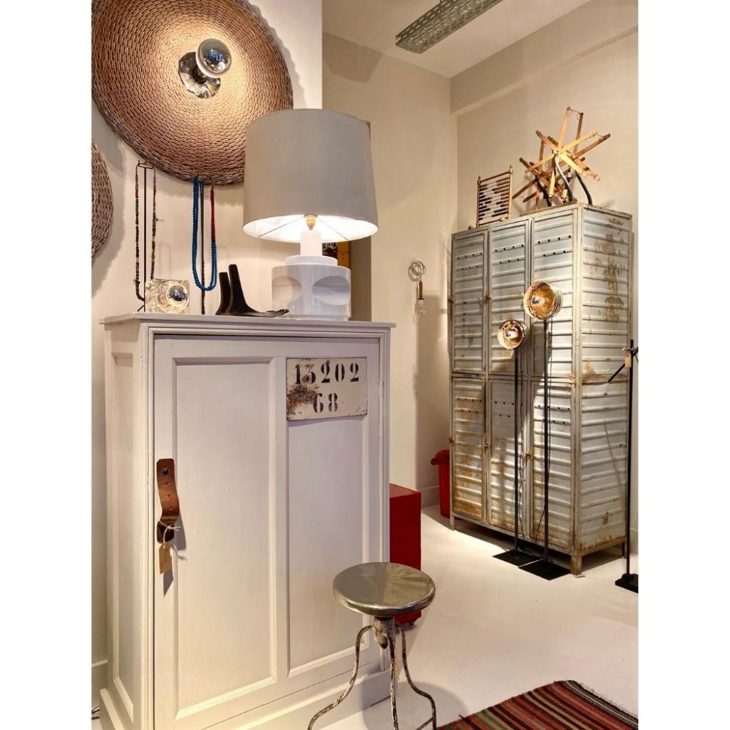 Esprit shabby chic, avec une armoire en bois et casiers en metal. Applique lumineuse avec support en vannerie, creation Zoe Morel.